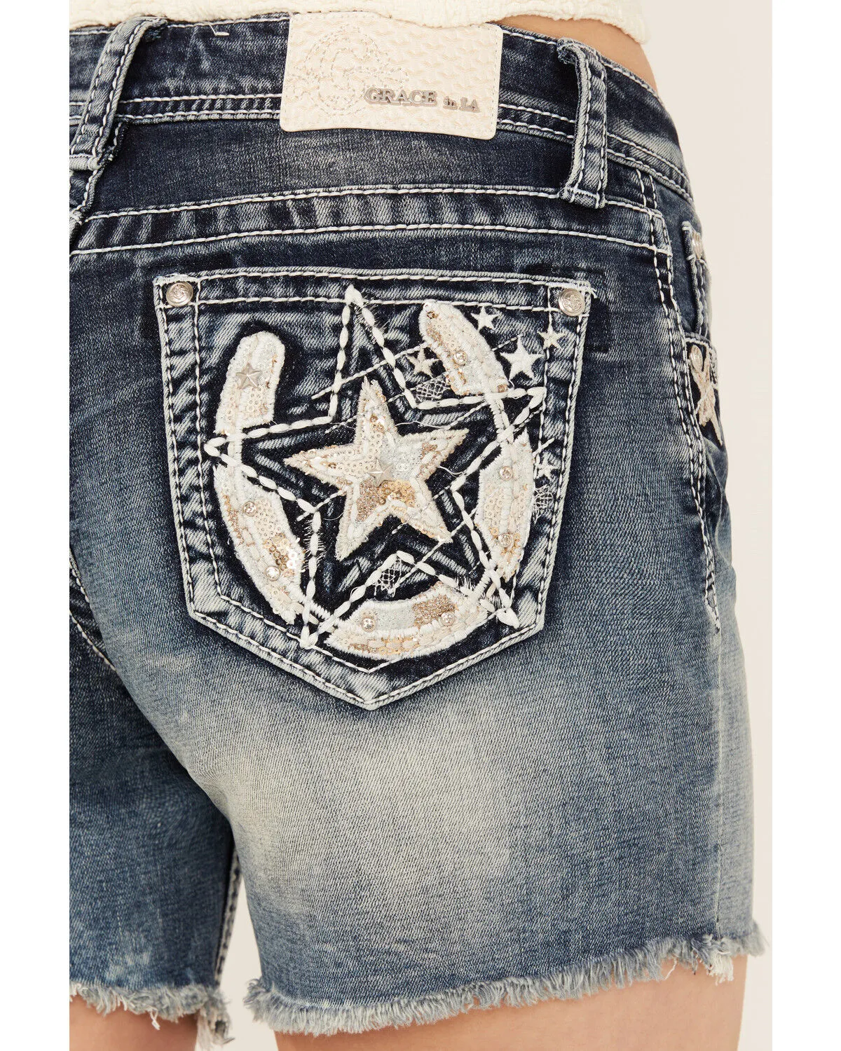 Product Name:  Grace In LA Light Wash Sequin Horseshoe Pocket Mid Rise Cutoff Stretch Denim Jeans